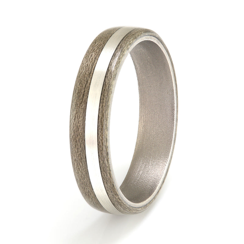 Manly wedding band | 5mm wide titanium ring with a greyed maple outer and an off centre inlay of silver | by Eco Wood Rings
